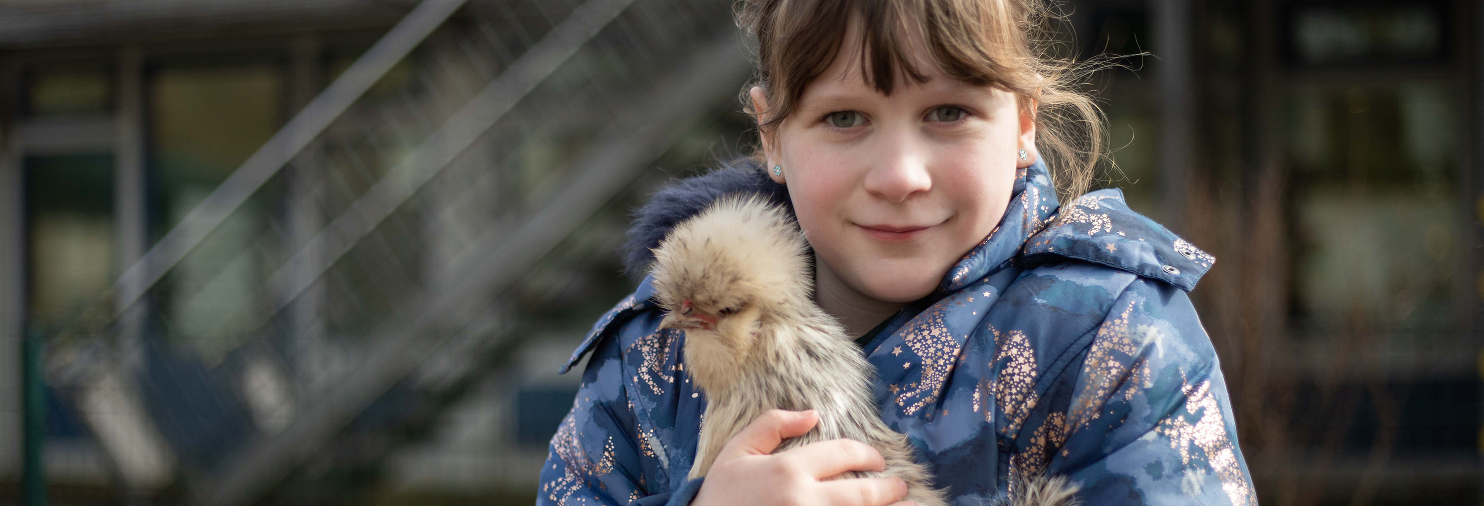 Student holding a chicking